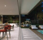 Poolside and outdoor area of Al Tay Hills villas in Dubai with luxury furniture and evening lighting.