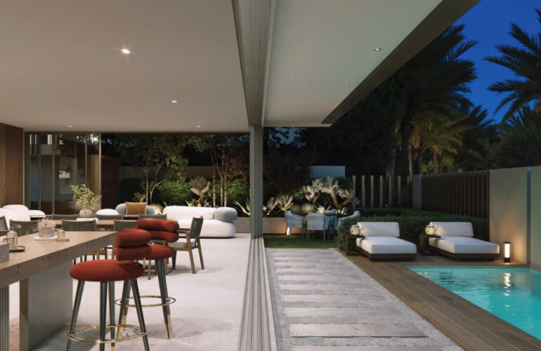 Poolside and outdoor area of Al Tay Hills villas in Dubai with luxury furniture and evening lighting.