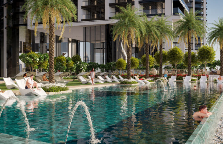 Infinity-edge leisure pool with sunbeds and palm trees at Sobha Central