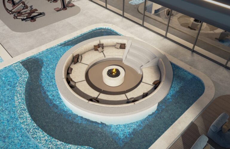 Modern circular lounge with seating area and firepit surrounded by a pool at SAMANA Sky Views.