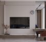 Minimalist living room with built-in TV wall and warm lighting at SAMANA Sky Views.
