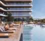 A community pool at Samana Ibiza in Dubai, located outside the apartment and resembling a public pool. People are sitting around the pool, and some are swimming in it