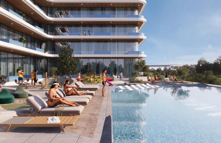 A community pool at Samana Ibiza in Dubai, located outside the apartment and resembling a public pool. People are sitting around the pool, and some are swimming in it