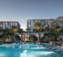 Central swimming pool surrounded by palm trees and luxury residences at Sera Dubai