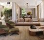 Guest room at The Acres Estates in Dubailand with sofas arranged together, a table, and a set of bathtubs, with the interior of the house clearly visible.