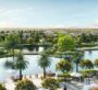 he Acres Estates at Dubailand Villa An aerial photo showing an island with a river flowing through the center. Trees surround the island, and the land around it resembles a beach.