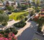 Park inside the villa yard at The Acres Estates in Dubailand with green spaces, paved pathways, sidewalks, and plenty of flowers and trees surrounding the area