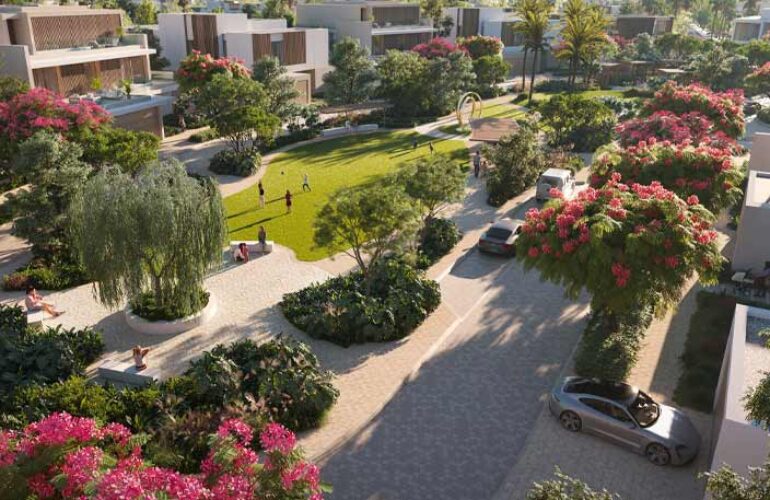 Park inside the villa yard at The Acres Estates in Dubailand with green spaces, paved pathways, sidewalks, and plenty of flowers and trees surrounding the area