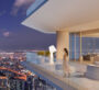 A white balcony at The Chedi Private Residences in Dubai, with a night view of homes and apartments, as a woman or girl looks outside.