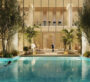 A large pool in the courtyard of a villa at The Chedi Private Residences in Dubai, with the villa illuminated at night. The white villa shines, and the pool area is surrounded by green trees and plants