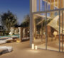 Another angle of the pool at The Chedi Private Residences in Dubai, this time showing the villa's exterior through large glass windows. White stairs leading upwards are visible in the view.