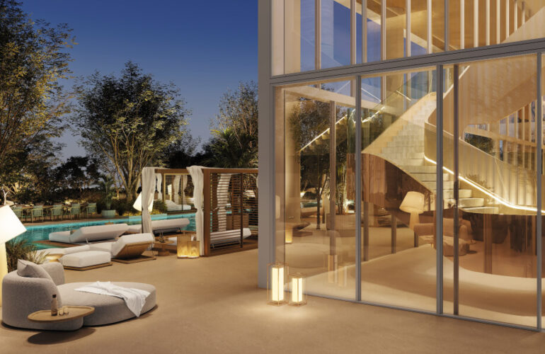 Another angle of the pool at The Chedi Private Residences in Dubai, this time showing the villa's exterior through large glass windows. White stairs leading upwards are visible in the view.