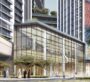 Glass-front commercial entrance of The Eden with landscaped surroundings