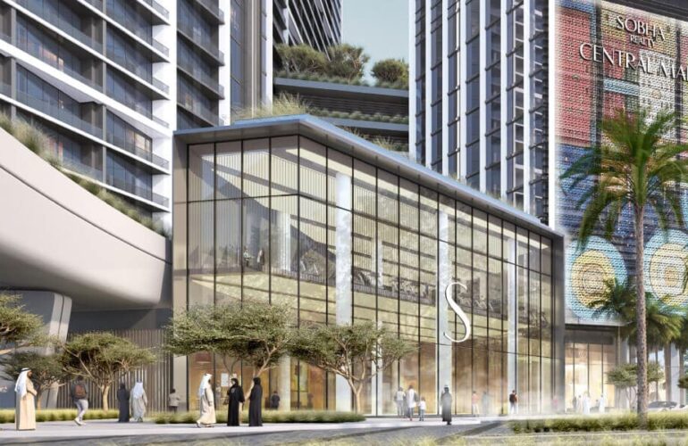 Glass-front commercial entrance of The Eden with landscaped surroundings