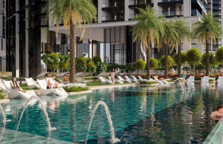 Resort-style swimming pool at The Eden surrounded by palm trees and sun loungers