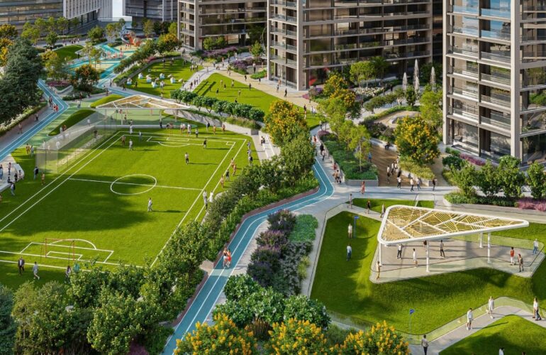 Green outdoor sports area in The Eden community with football field and walking tracks