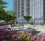 At The Element at Sobha One Apartments park in Dubai, two people are playing ping pong. Trees and purple flowers surround the park, with sunny weather