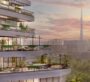 A balcony of an apartment at Trinity Balcony-Closeup in Dubai, overlooking a green space with the city and Burj Khalifa visible in the distance.