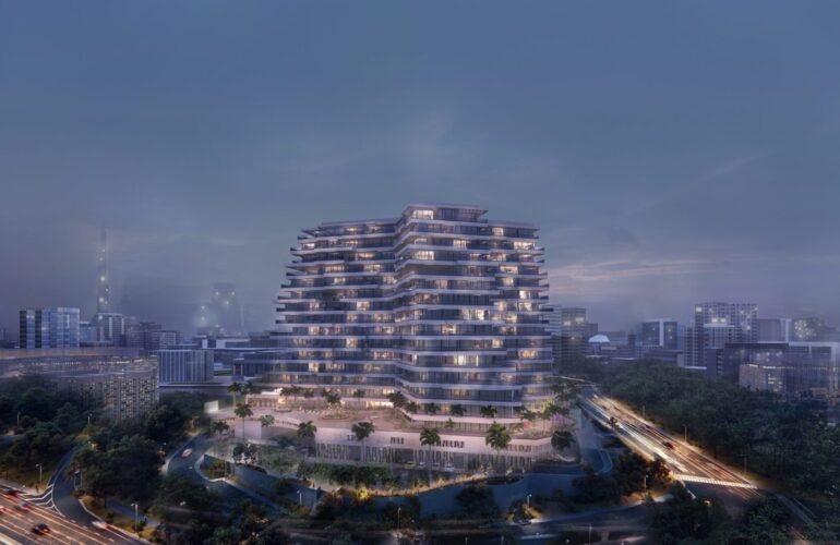 A distant view of Trinity Exterior-Night in Dubai, at night with cloudy skies and the apartment lights illuminating its beautiful exterior