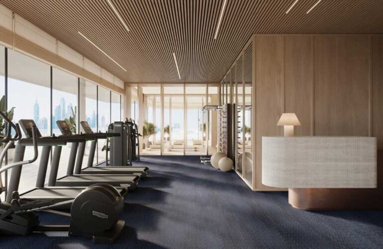 Fully equipped gym with wooden interiors and modern equipment at Dubai Harbour Residences