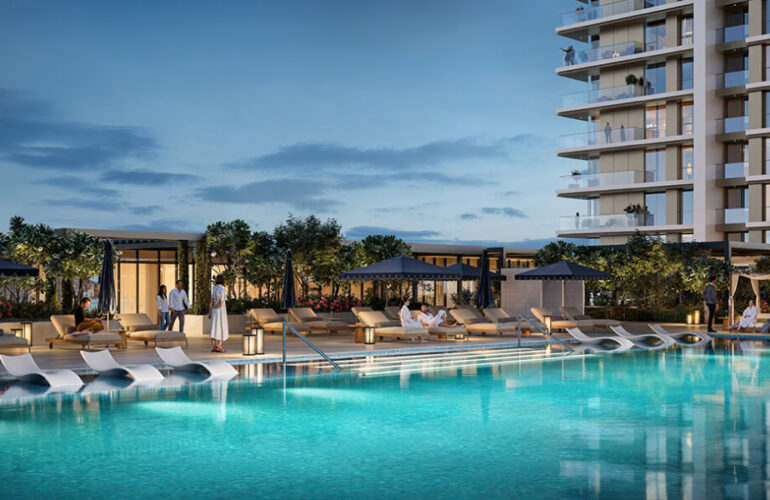 Large infinity pool surrounded by sun loungers and greenery at Lyvia by Palace